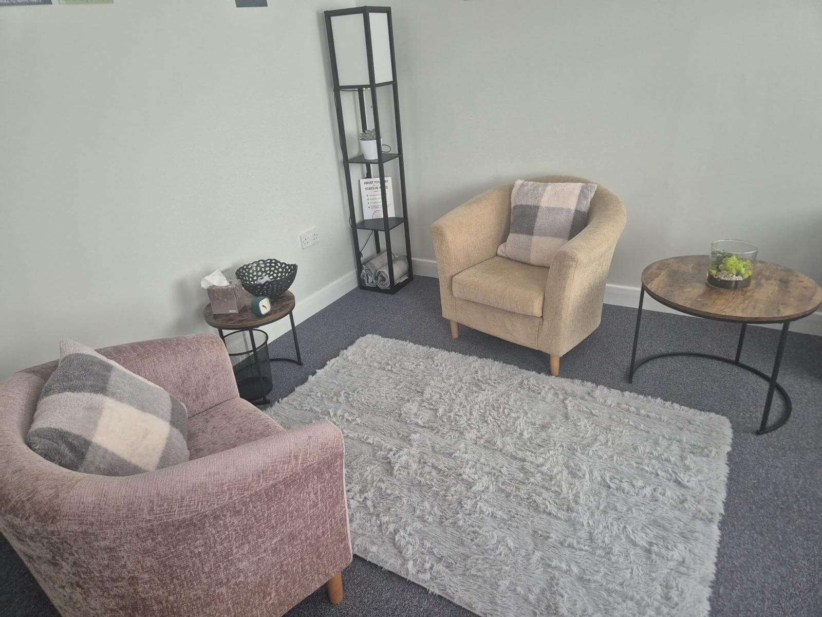 Comfortable and welcoming DM Counselling therapy room featuring soft armchairs, a cosy rug, and calming decor